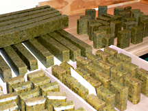 Block of soap being cut into bars